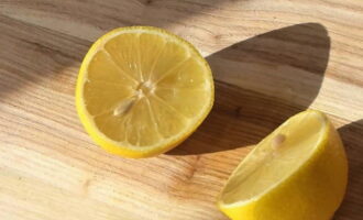 Лимон разрезаем напополам и выжимаем сок, процеживая через сито.